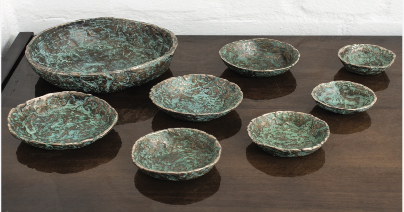 Collection of eight bronze bowls with verdigris patina